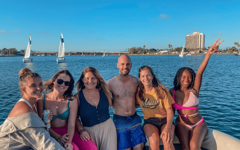 Travel group smiling on a boat in San Diego.